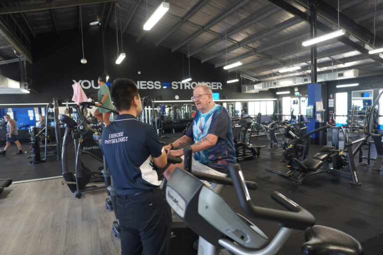 Exercise Physiologist Leon supporting a diabetes client during low-impact cardio.