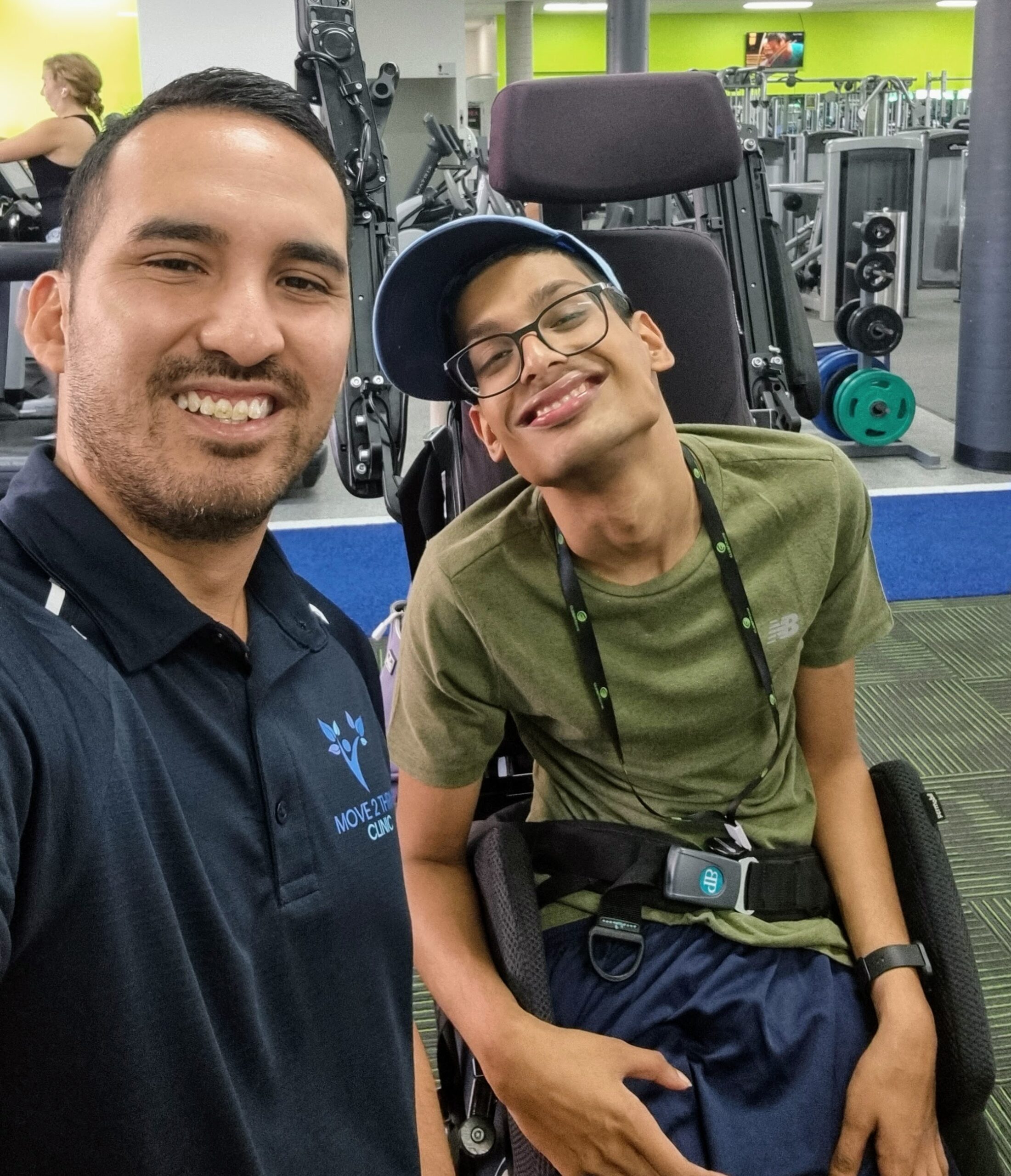 Exercise Physiologist Jeremy with NDIS participant in the gym smiling