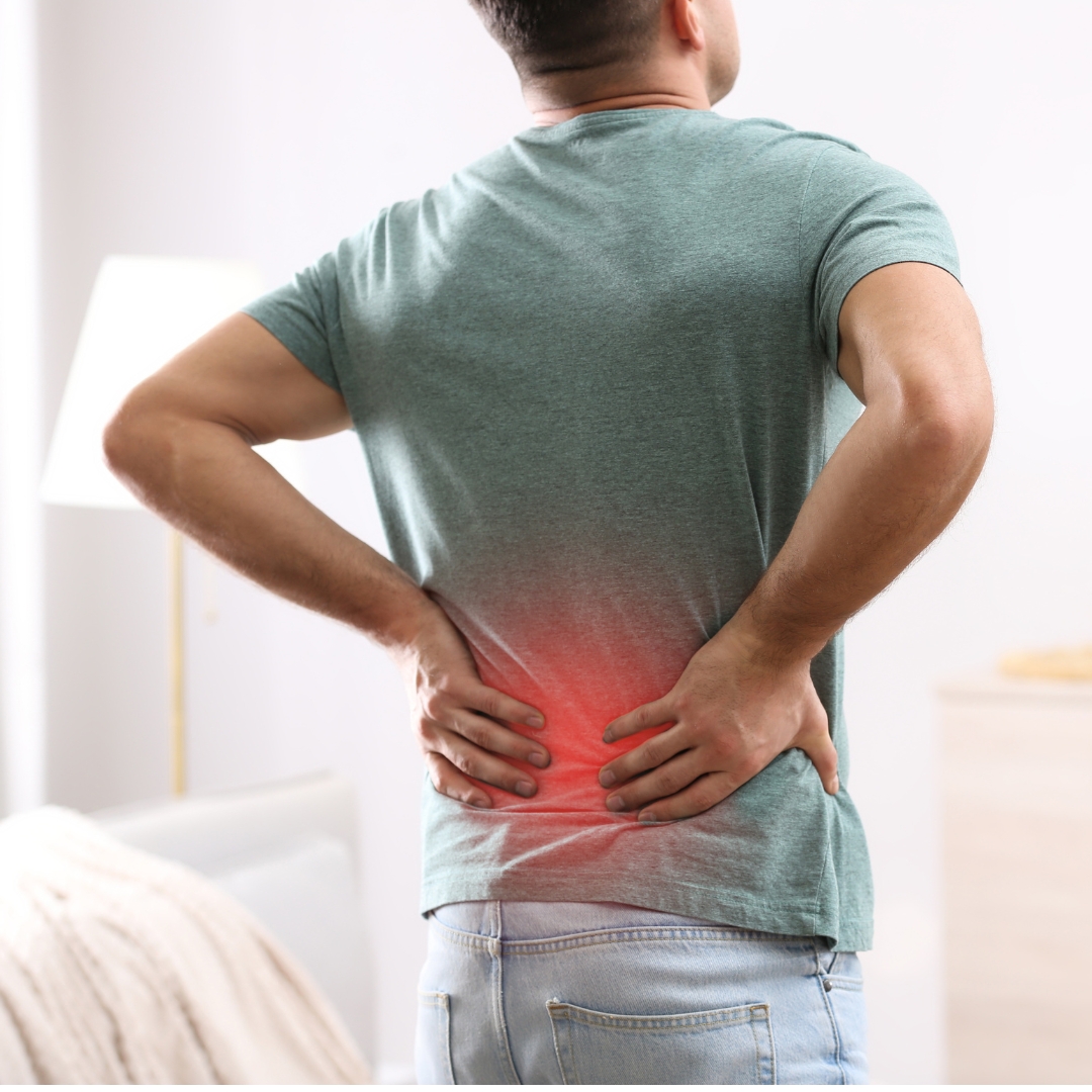 Man holding his lower back with visible pain, illustrating chronic or persistent low back pain.