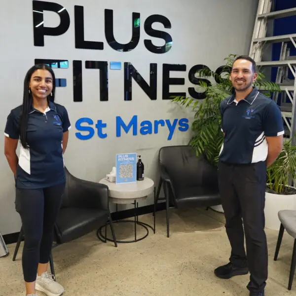Amisha and Jeremy at Plus Fitness St Marys standing in front of the gym sign