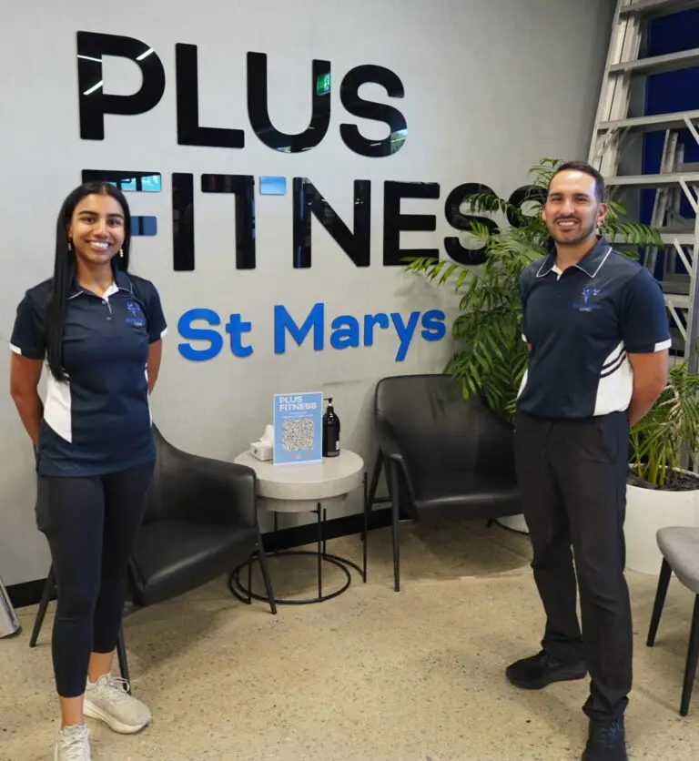 Amisha and Jeremy at Plus Fitness St Marys standing in front of the gym sign