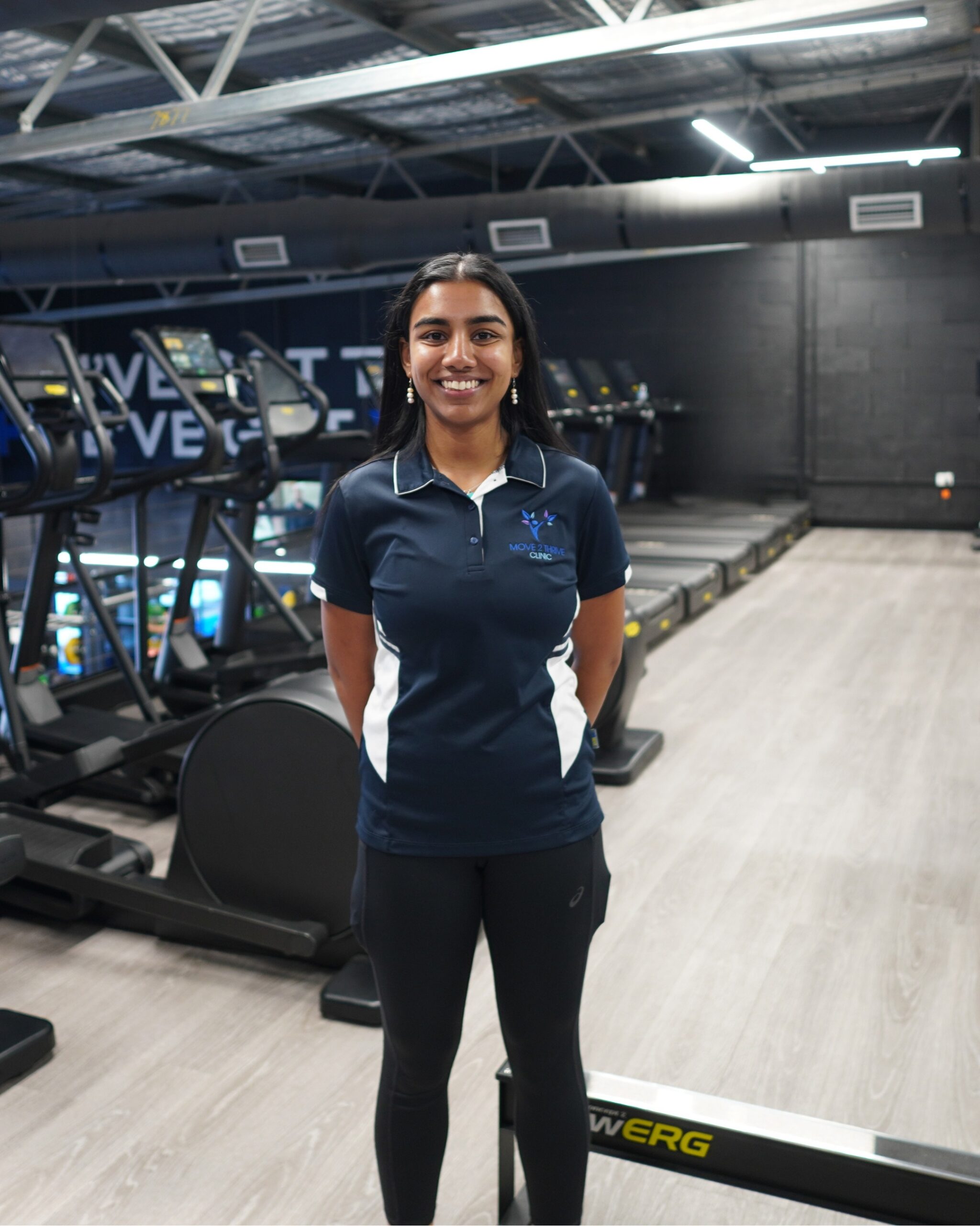 Amisha Singh, Exercise Physiologist at Move 2 Thrive Clinic, standing in the gym